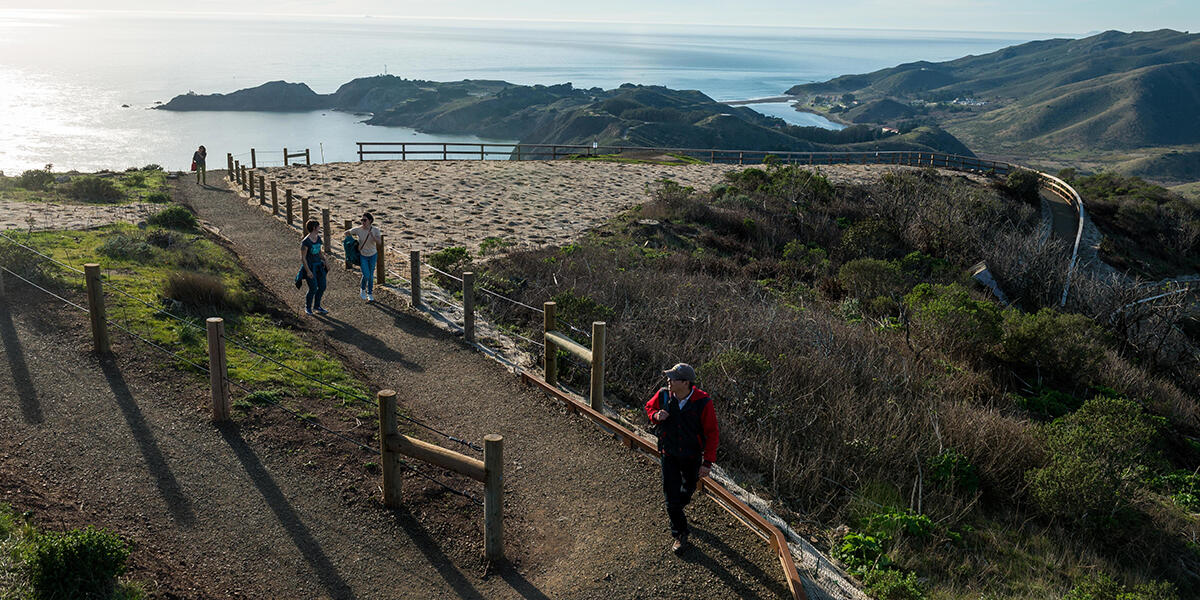 Hikers explore a newly built segment of the Hawk Hill Trail