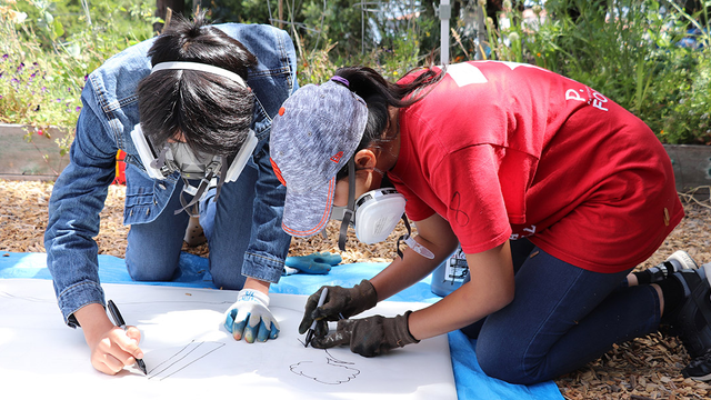 Two youth working on a project together