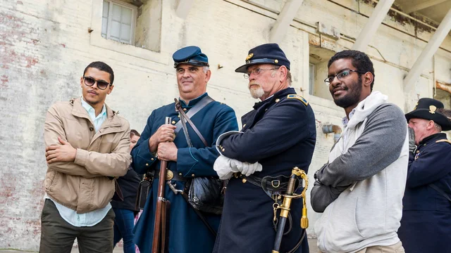 A couple of Alcatraz visitors pose with Civil War Reenactment actors for a photo during Living History Day on Alcatraz Island.