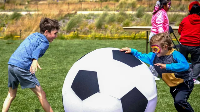 Children play with a giant soccer ball at the Presidio of San Francisco