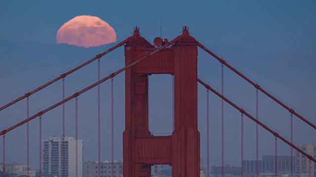 Full moon rising over Golden Gate Bridge
