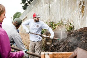 Parks Conservancy staff shoveling compost at the Alcatraz Historic Gardens