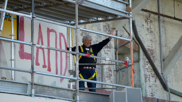 Alcatraz occupier waves after painting political slogan during 50th anniversary celebration