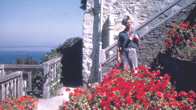 An Alcatraz incarcerated gardener stands in Officers' Row
