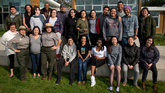 A group of educators stand together outside a building in a national park