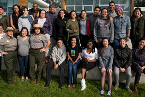 A group of educators stand together outside a building in a national park