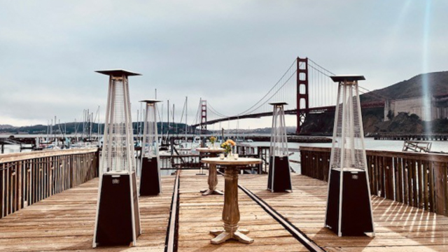 A dining table set on the waterfront of Fort Baker.
