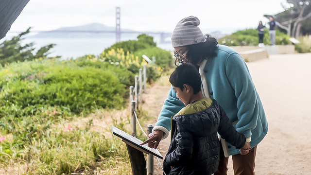 A family checks out a StoryWalk at Lands End in San Francisco.