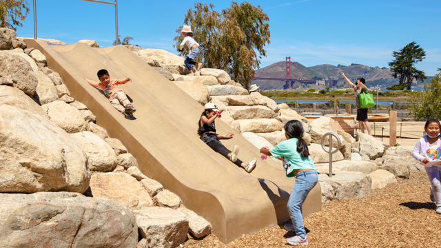 Children playing on Bluff Slide at Outpost