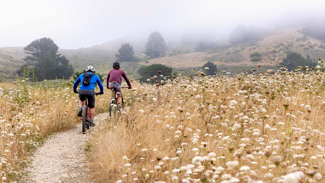 Two cyclists mountain biking a trail in Rancho Corral de Tierra