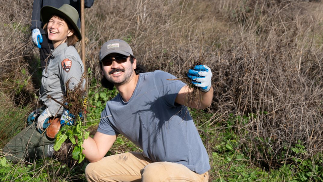 A volunteer strikes a pose while helping to restore Tennessee Valley.