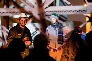 NPS park ranger gives a candlelight tour to guests at Fort Point