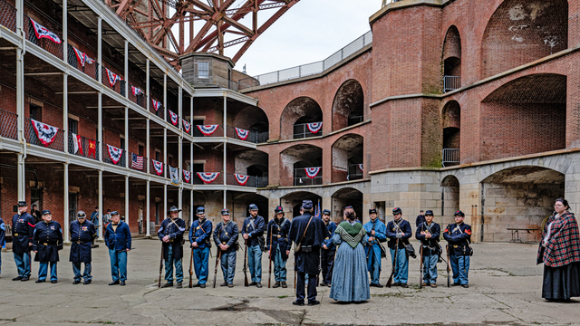 People gathered at Fort Point National Historic Site on Living History Day, dressed in civil war era union uniforms for reenactment.