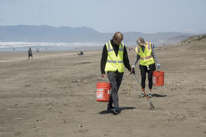 Volunteer removing litter at Ocean Beach