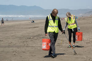 Volunteer removing litter at Ocean Beach