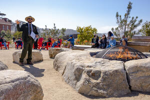 NPS Park Ranger gives a presentation to visitors at the Presidio Campfire Circle