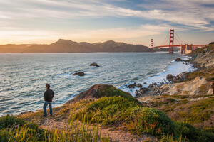 Hiker watching sunset on the Batteries to Bluffs trail