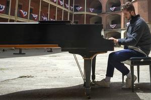 Man plays piano while at Fort Point National Historic Site