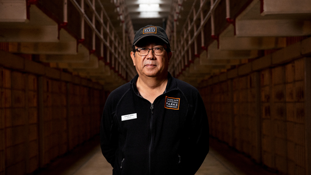 Alcatraz staff member Edwin Sera stands in the Alcatraz Cellhouse.