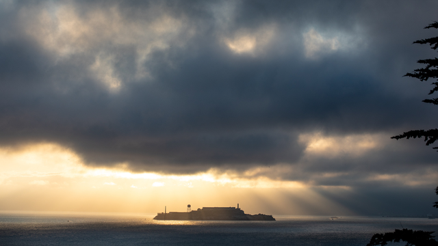 Sunlight breaking through stormy cloud over Alcatraz