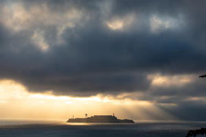 Sunlight breaking through stormy cloud over Alcatraz
