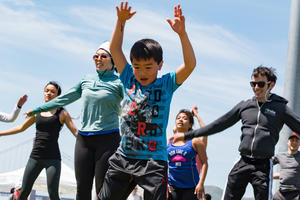 Kid jumping against blue sky