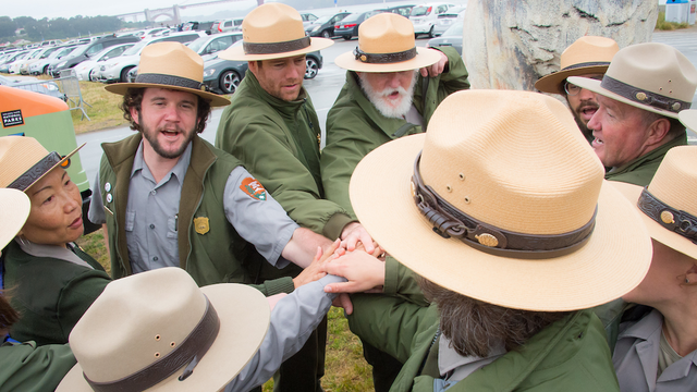 A group of NPS rangers rally together during the Junior Ranger Jamboree in 2016.