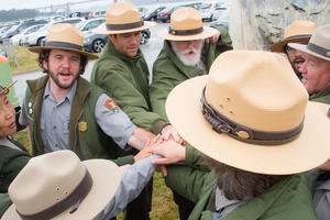 A group of NPS rangers rally together during the Junior Ranger Jamboree in 2016.