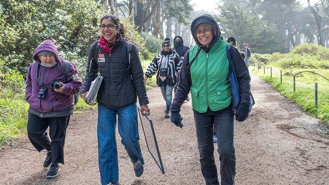 A group of people walking down a path at Lands End in San Francisco.