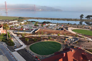 New Presidio Tunnel Tops under construction, with Golden Gate Bridge in the distance