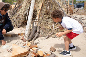 An Adventure Guide engages with a young person at the Outpost at Presidio Tunnel Tops.