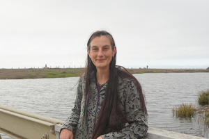 Portrait of Data manager Lizzy Edson smiling on the bridge by Rodeo Lagoon.