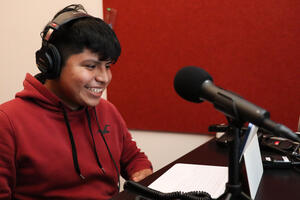 Crissy Field Center IYEL intern speaks into a microphone for a youth program podcast