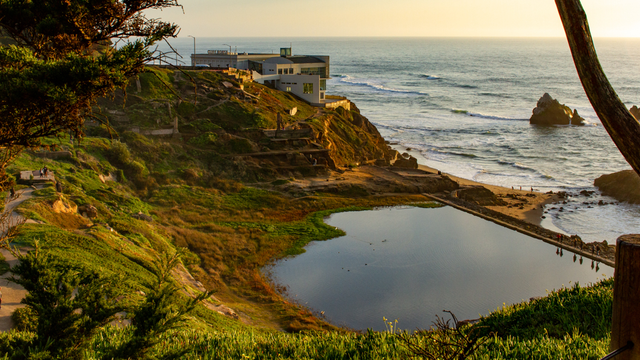 A sunset view overlooking Lands End, the ruins of Sutro Baths, and the ocean.