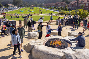 A crowd gathers around the Campfire Circle at the newly opened Presidio Tunnel Tops.