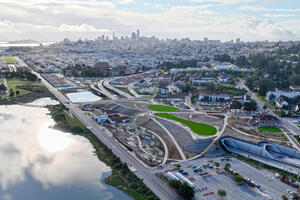 An aerial view of the Presidio Tunnel Tops, looking out to the San Francisco city skyline.