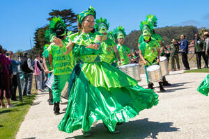 The dancers of Fogo Na Roupa celebrate in bright green regalia at the newly opened Presidio Tunnel Tops.