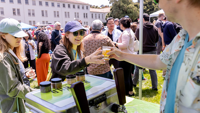 Buck Wild Brewing hands event attendee a tasting glass full of beer at Parks4All: Brewfest, a beer festival and fundraiser, on Saturday, July 29th, 2023 in the Presidio of San Francisco.