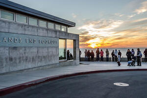 The outside of Lands End Lookout at sunset