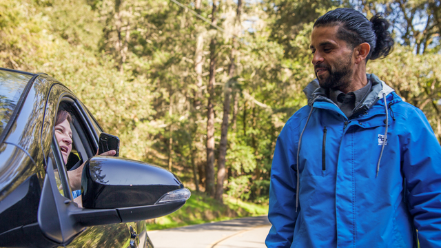 Driver shows Muir Woods parking reservation to attendent 