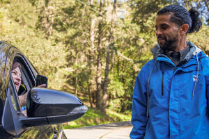 Driver shows Muir Woods parking reservation to attendent 