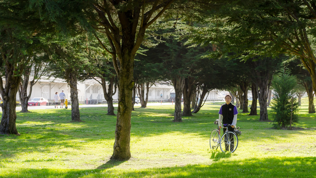 Cyclist rests by the trail through east Crissy Field