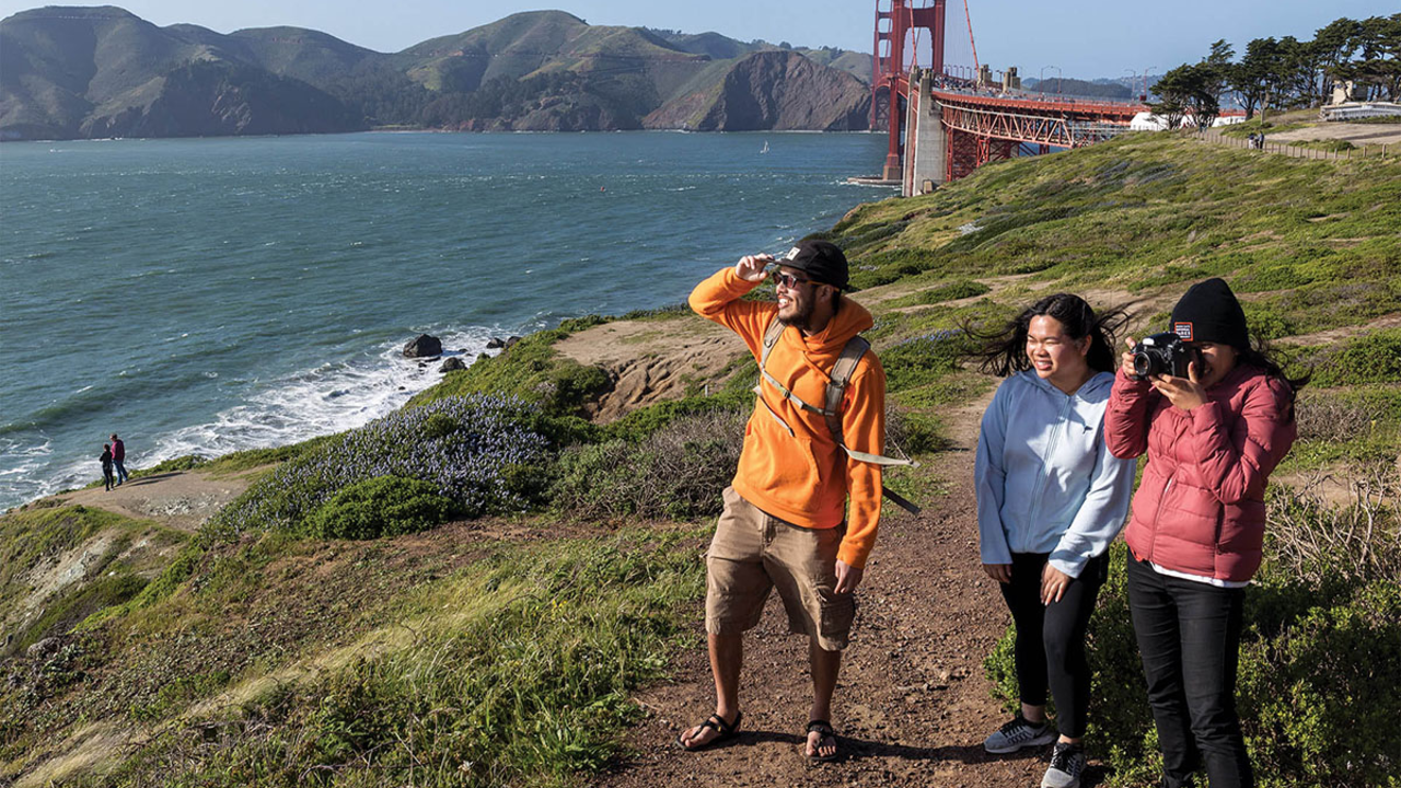 Hiking at the Golden Gate Overlook near the Golden Gate Bridge. Photo from the Golden Gate National Parks Conservancy's annual report. Hiking at the Golden Gate Overlook near the Golden Gate Bridge.