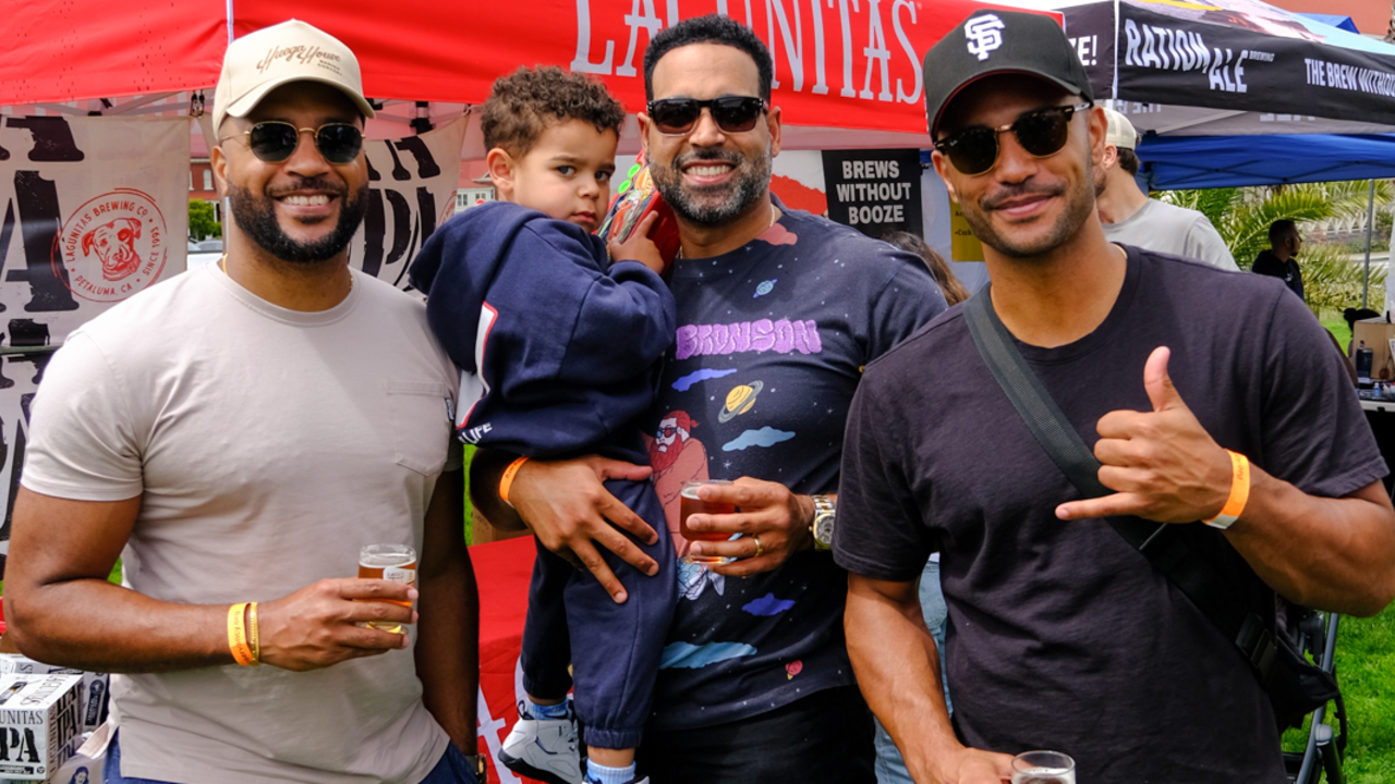 A family group smiles for a photo at Parks4All: Brewfest in the Presidio of San Francisco
