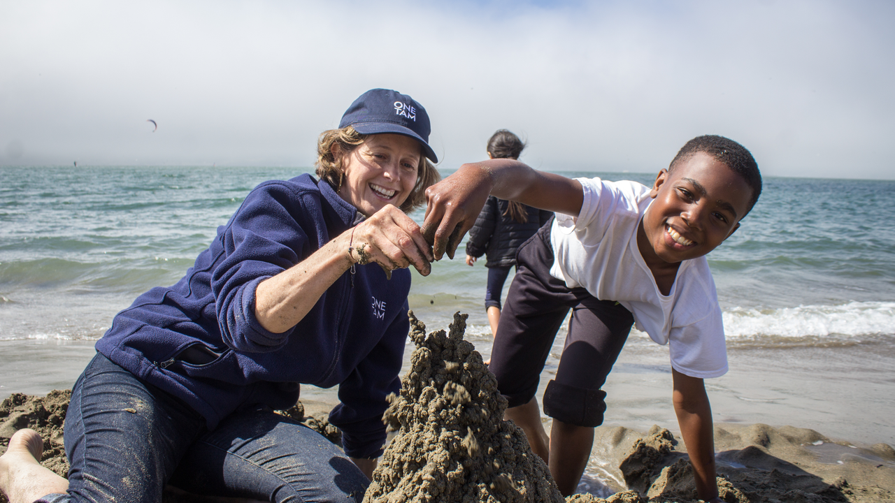Having fun with sand on the beach.