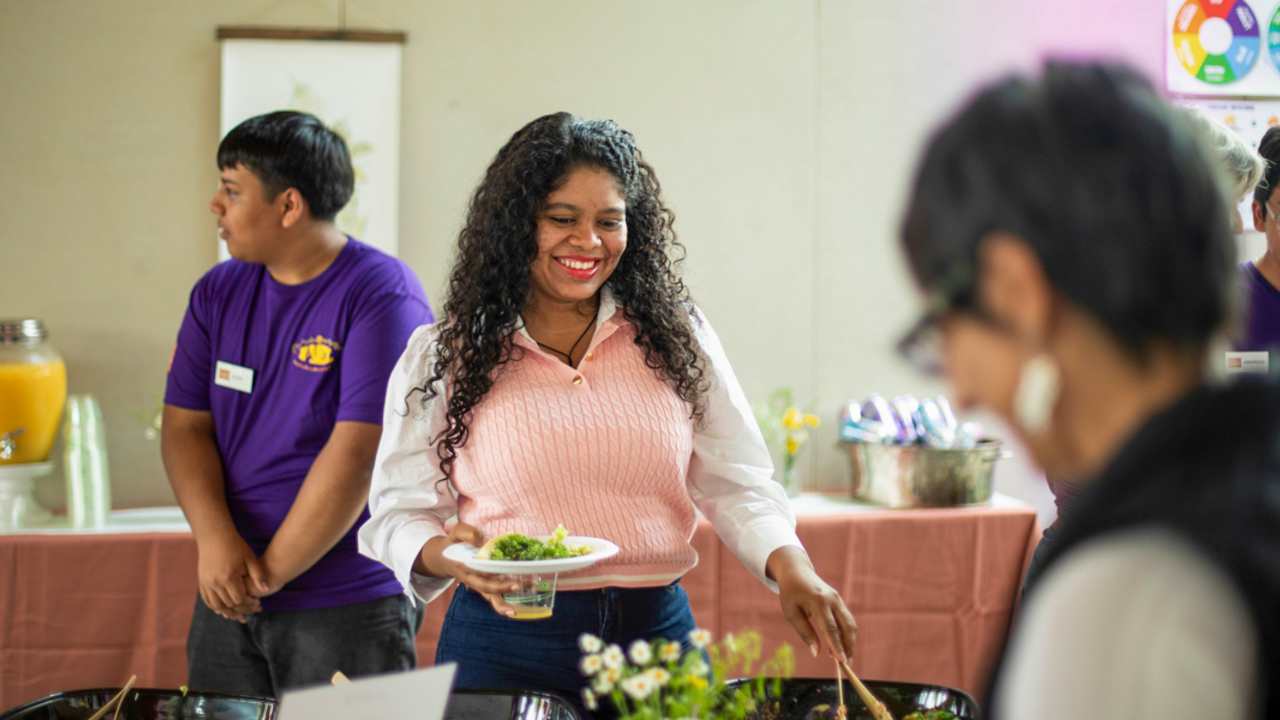Goldman Prize Award Youth Reception attendee happily serving herself food at the Crissy Field Center.
