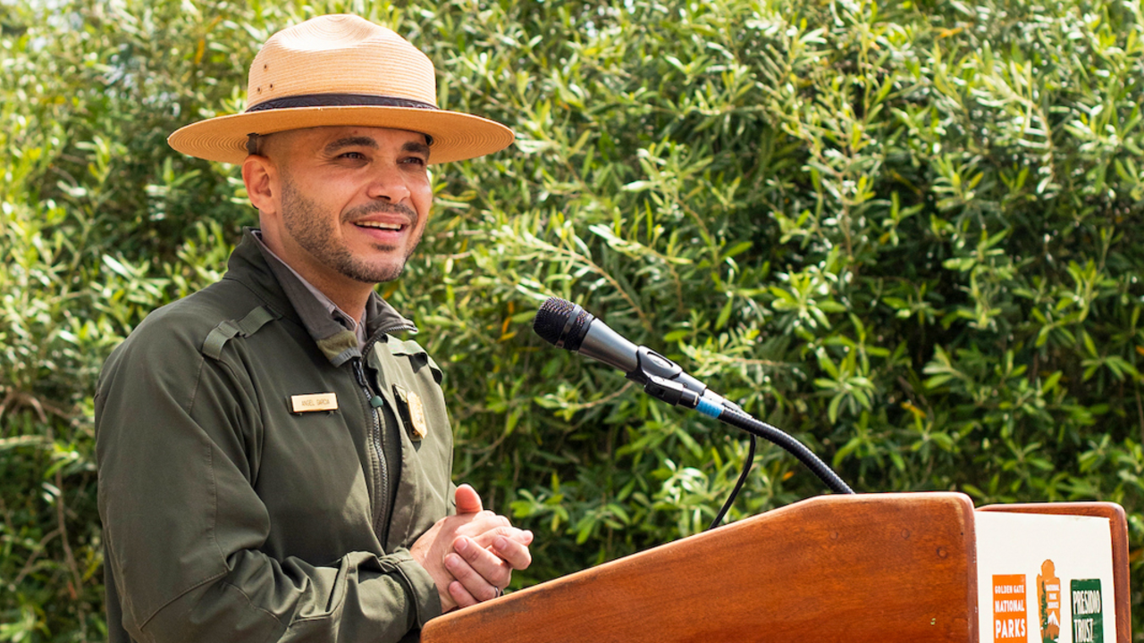 An NPS Ranger speaks at the podium during the Goldman Prize Awards Youth Reception at Crissy Field Center.