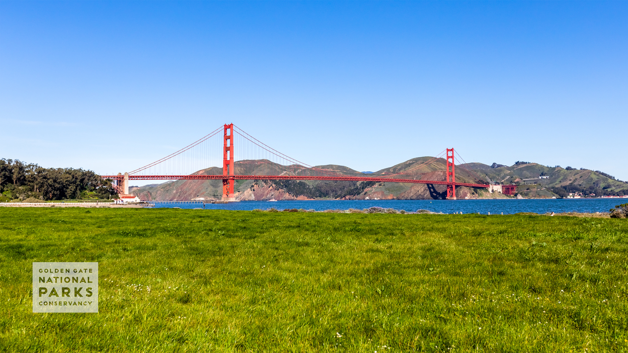 A sunny day scenic photo from the Crissy Field lawn with the Golden Gate Bridge and Fort Point seen in the background. Photo by Kelly Sullivan.