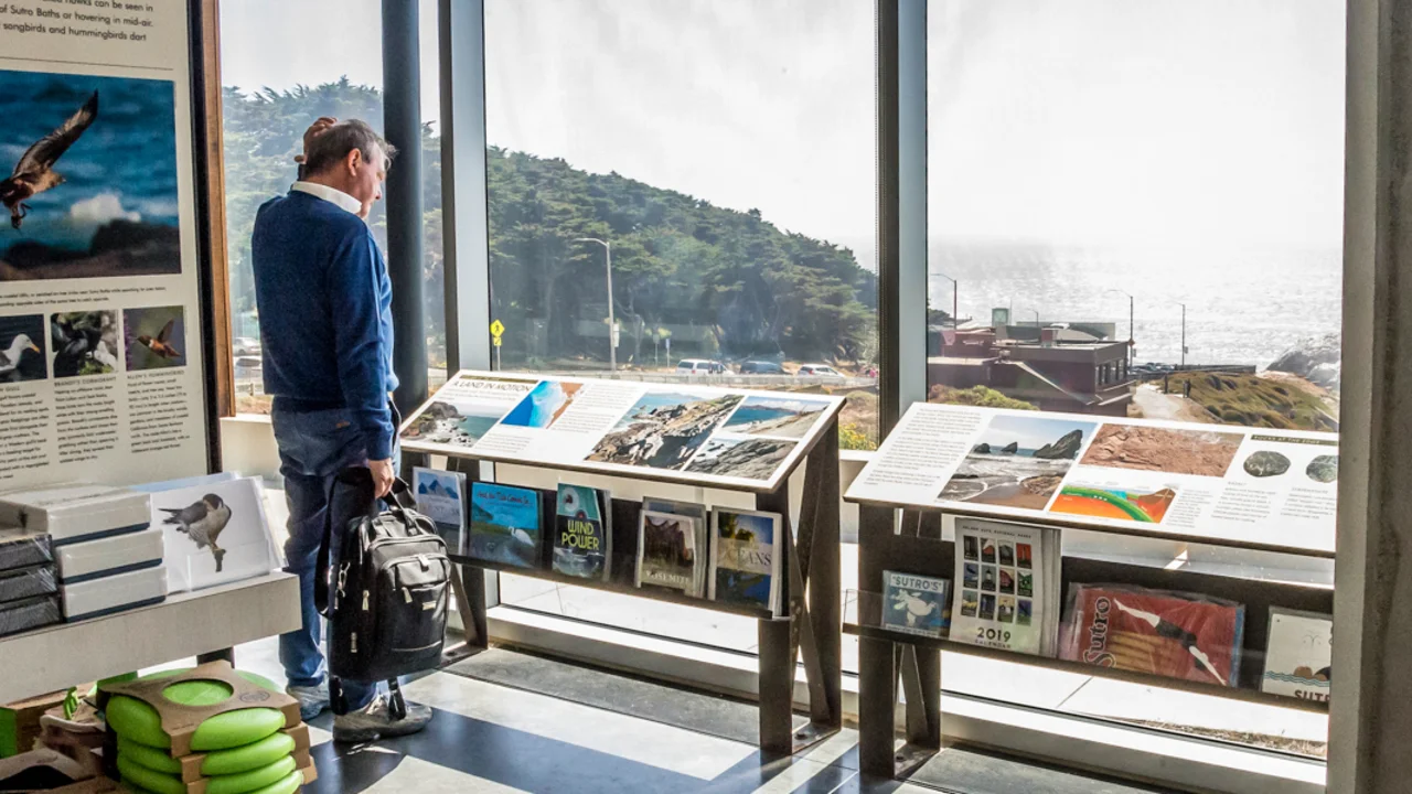 A park visitor reads an informational display at Lands End Lookout in San Francisco.