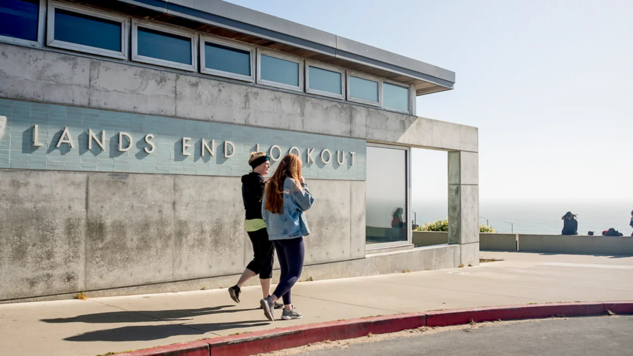 two people walking by the Lands End Lookout visitor center and store in San Francisco
